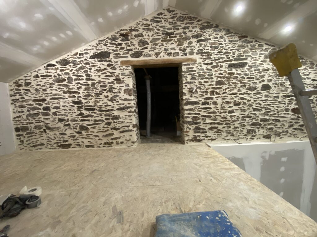 Mur intérieur enduit en pierre apparente